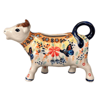 A picture of a Polish Pottery Cow Creamer (Butterfly Bliss) | D081S-WK73 as shown at PolishPotteryOutlet.com/products/cow-creamer-butterfly-bliss-d081s-wk73