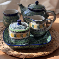 A picture of a Polish Pottery CA 10 oz. Creamer (Lemons and Leaves) | A341-2749X as shown at PolishPotteryOutlet.com/products/c-a-10-oz-creamer-lemons-and-leaves-a341-2749x