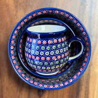 A picture of a Polish Pottery Large Belly Mug (Rings of Flowers) | K068U-DH17 as shown at PolishPotteryOutlet.com/products/large-belly-mug-dh17-k068u-dh17
