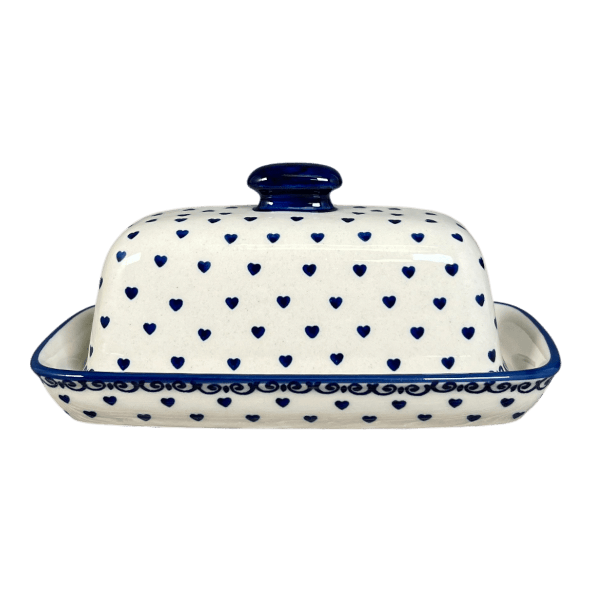 Ceramic butter dish with blue heart pattern on a white background