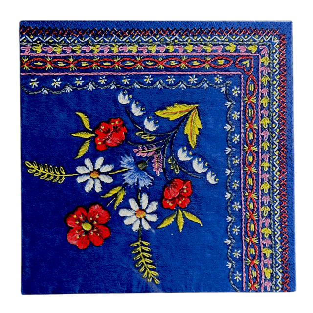 A blue paper napkin with a colorful floral folk embroidery pattern.
