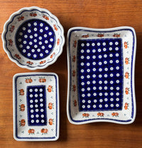 A picture of a Polish Pottery Serving Dish, Angular, 10" x 7" in "Persimmon Dot" by Zaklady | Y1935A-D479 as shown at PolishPotteryOutlet.com/products/angular-serving-dish-peacock-peaches-cream-y1935a-d479