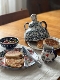 A picture of a Polish Pottery The Collectible Cheese Lady (Poppy Persuasion) | B001S-P265 as shown at PolishPotteryOutlet.com/products/the-collectible-cheese-lady-poppy-persuasion-b001s-p265