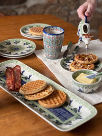 A picture of a Polish Pottery Cow Creamer (Green Tea Garden) | D081T-14 as shown at PolishPotteryOutlet.com/products/cow-creamer-green-tea-garden-d081t-14