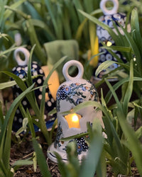 A picture of a Polish Pottery Large Bell Luminary (Blue Tethered Blossoms) | NDA138-4 as shown at PolishPotteryOutlet.com/products/large-bell-luminary-bold-blue-blossoms-nda138-4