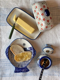 A picture of a Polish Pottery Butter Dish, American, 4" x 7.5" in "Dusty Daisy Chain" by Manufaktura | M074U-AS55 as shown at PolishPotteryOutlet.com/products/american-butter-dish-dusty-daisy-chain