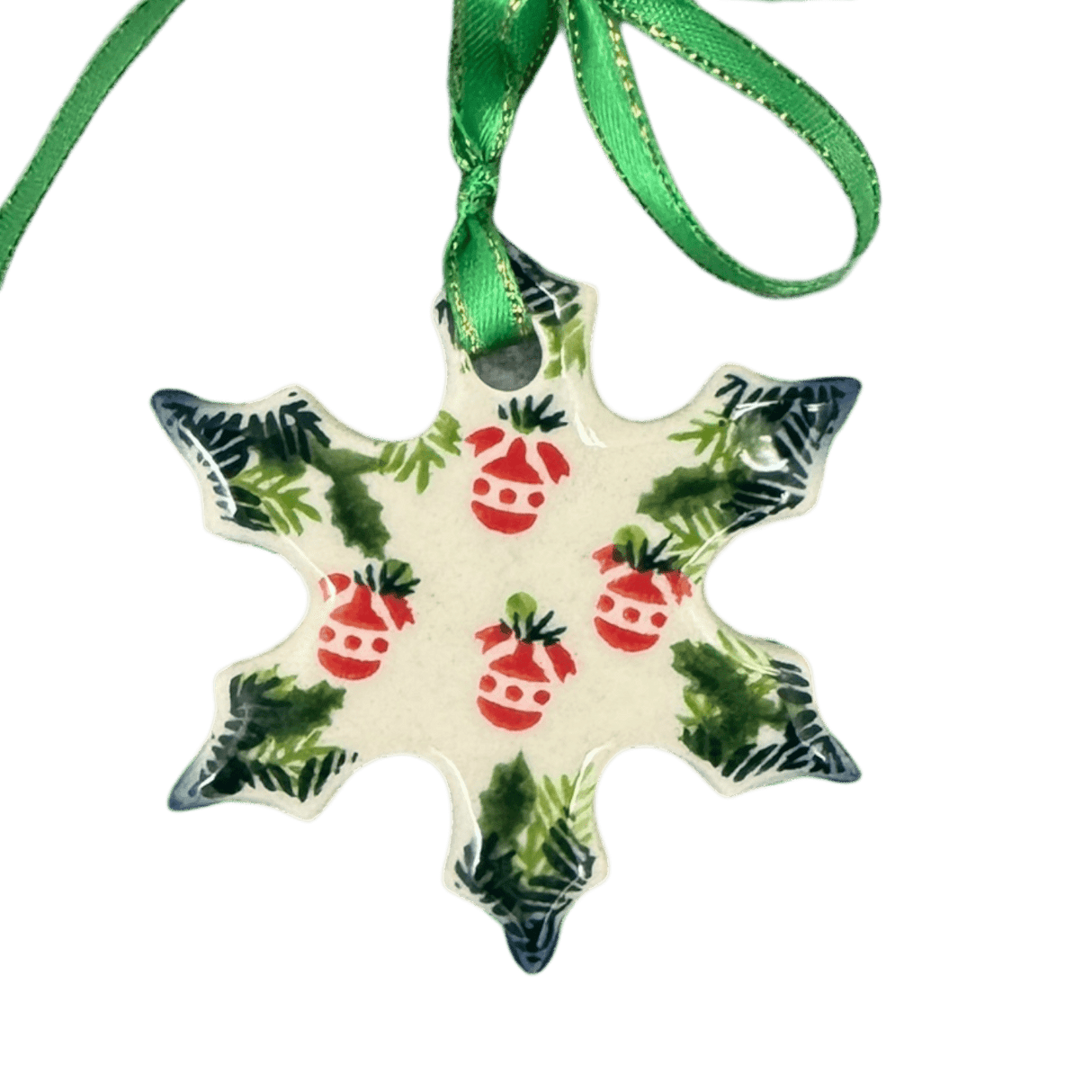 Decorative snowflake ornament with red berries and green leaves on a white background