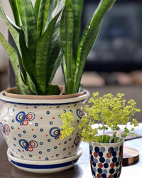 A picture of a Polish Pottery 5.5" Tall Flower Pot (Orange Bouquet) | GDN03-UWP2 as shown at PolishPotteryOutlet.com/products/5-5-flower-pot-orange-bouquet-gdn03-uwp2