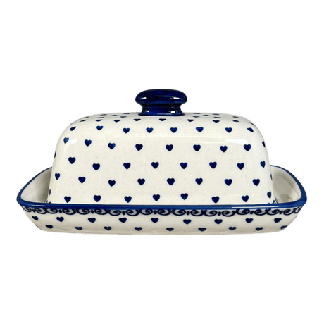 Ceramic butter dish with blue heart pattern on a white background