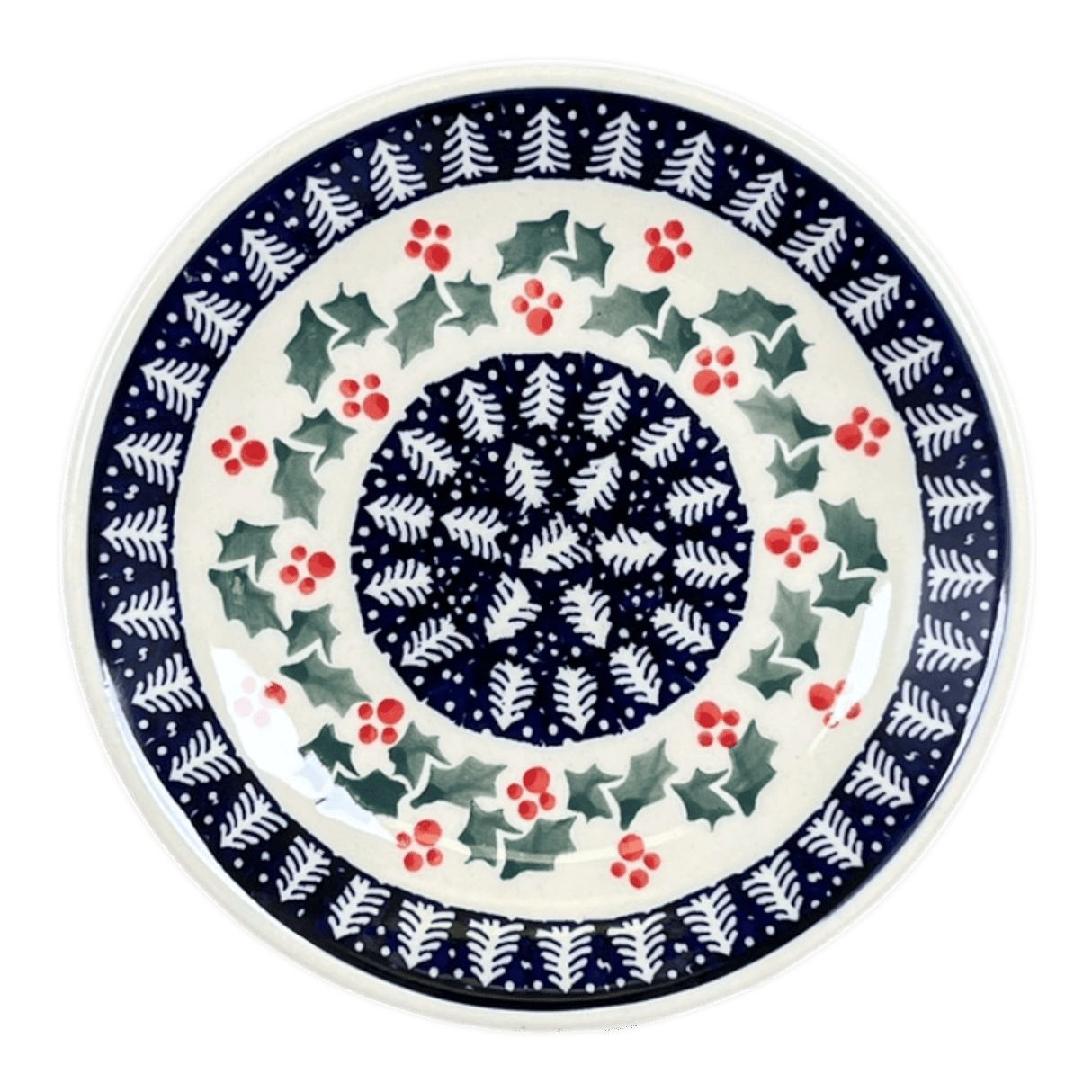 Ceramic plate with festive design featuring holly leaves and berries on a white background