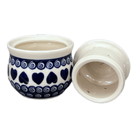 A picture of a Polish Pottery Zaklady Butter Crock (Swirling Hearts) | Y1512-D467 as shown at PolishPotteryOutlet.com/products/butter-crock-swirling-hearts-y1512-d467