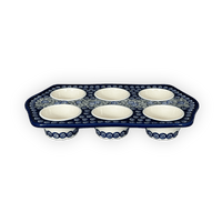 A picture of a Polish Pottery Zaklady Muffin Pan (Spring Swirl) | Y1778-A1073A as shown at PolishPotteryOutlet.com/products/muffin-pan-spring-swirl-y1778-a1073a
