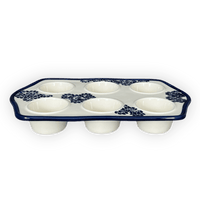 A picture of a Polish Pottery Zaklady Muffin Pan (Blue Floral Vines) | Y1778-D1210A as shown at PolishPotteryOutlet.com/products/muffin-pan-blue-floral-vines-y1778-d1210a