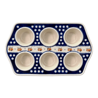A picture of a Polish Pottery Zaklady Muffin Pan (Persimmon Dot) | Y1778-D479 as shown at PolishPotteryOutlet.com/products/zaklady-muffin-pan-peacock-peaches-cream-y1778-d479