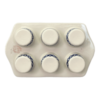 A picture of a Polish Pottery Zaklady Muffin Pan (Persimmon Dot) | Y1778-D479 as shown at PolishPotteryOutlet.com/products/zaklady-muffin-pan-peacock-peaches-cream-y1778-d479