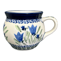 A picture of a Polish Pottery Zaklady 16 oz. Large Belly Mug (Blue Tulips) | Y910-ART160 as shown at PolishPotteryOutlet.com/products/zaklady-16-oz-belly-mug-blue-tulips-y910-art160