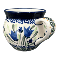 A picture of a Polish Pottery Zaklady 10 oz. Belly Mug (Blue Tulips) | Y911-ART160 as shown at PolishPotteryOutlet.com/products/zaklady-10-oz-belly-mug-blue-tulips-y911-art160