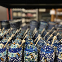 A picture of a Polish Pottery Honey Jar (Tulip Path) | NDA18-25 as shown at PolishPotteryOutlet.com/products/honey-jar-tulip-path-nda18-25