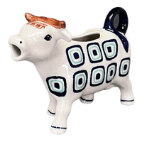 A picture of a Polish Pottery Cow Creamer (Green Retro) | D081U-604A as shown at PolishPotteryOutlet.com/products/cow-creamer-green-retro-d081u-604a
