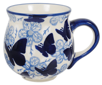 A picture of a Polish Pottery Medium Belly Mug (Blue Butterfly) | K090U-AS58 as shown at PolishPotteryOutlet.com/products/the-medium-belly-mug-blue-butterfly