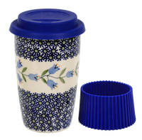 A picture of a Polish Pottery Travel Mug (Lily of the Valley) | K115T-ASD as shown at PolishPotteryOutlet.com/products/travel-mug-lily-of-the-valley