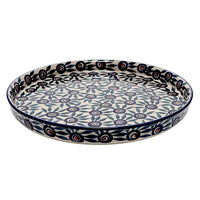 A picture of a Polish Pottery 10.25" Round Tray (Peacock Parade) | T153U-AS60 as shown at PolishPotteryOutlet.com/products/round-tray-peacock-parade